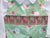 Close Up - Adorable Green Christmas Holiday Smocked and Embroidered Overall Pants for Boys - Santa and Candy Cane All Over Print Design