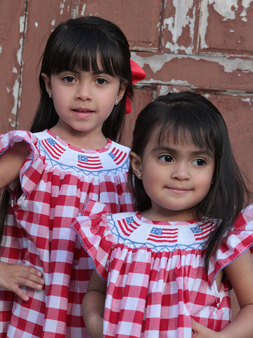 Hand smocked patriotic bishop dress for girls in red gingham with USA flag embroidery