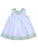 White A-line baby dress with green plaid collar trim, delicate pink rose bud embroidery, and matching hem trim. Perfect for springtime celebrations
